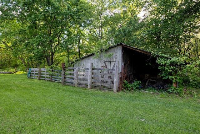 view of outbuilding with an outbuilding and fence