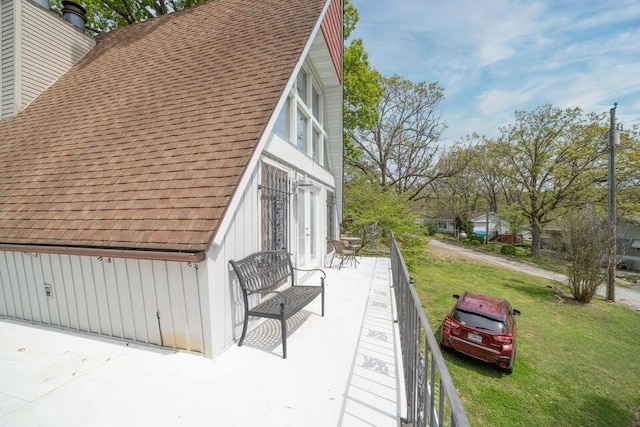 view of property exterior with a yard and a patio area