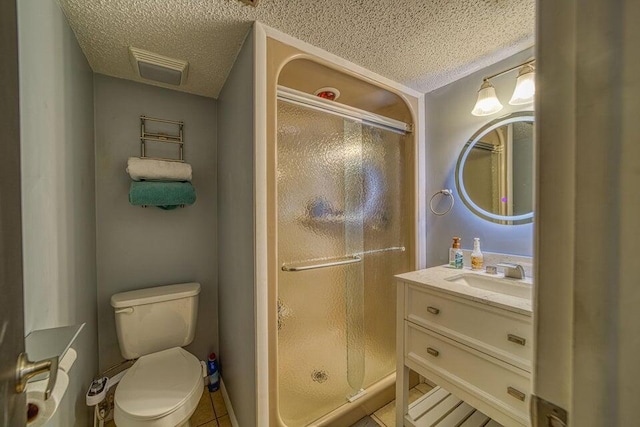 bathroom with tile patterned flooring, a textured ceiling, and a shower with door