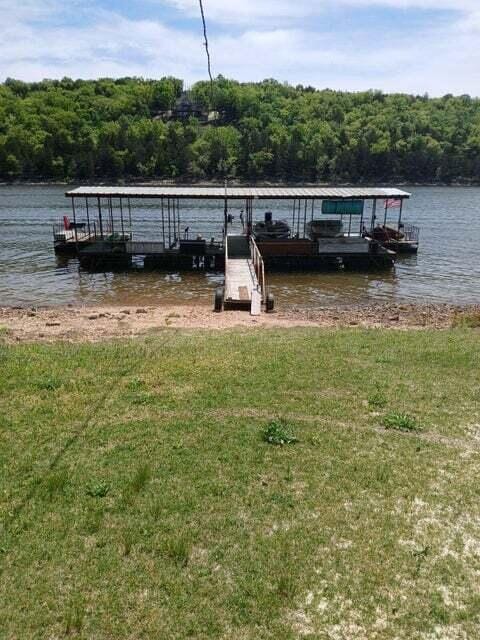 dock area featuring a yard and a water view