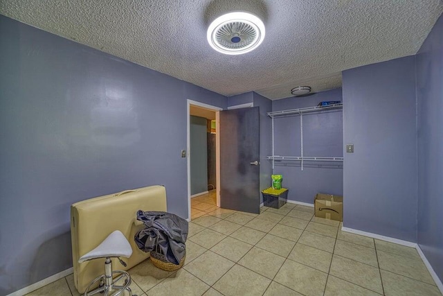 interior space with a textured ceiling and tile patterned floors