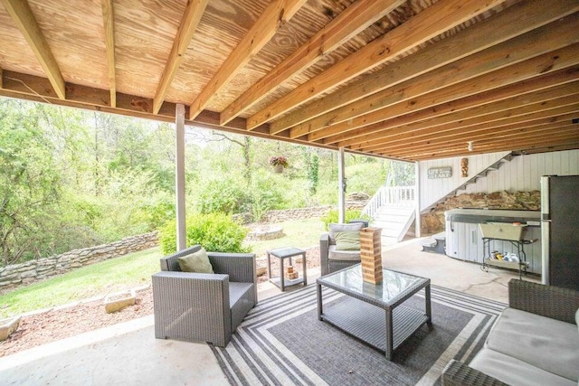 view of patio featuring outdoor lounge area and a hot tub