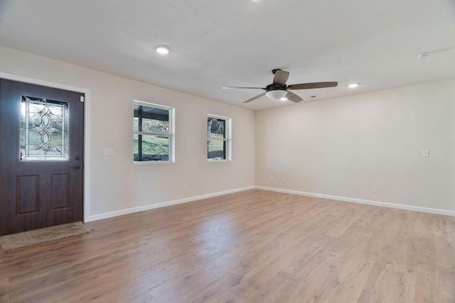 entrance foyer with ceiling fan, light hardwood / wood-style floors, and a textured ceiling