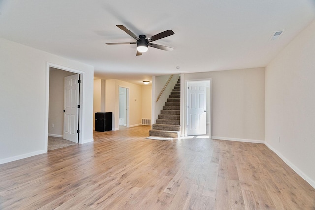 spare room with light wood-type flooring and ceiling fan