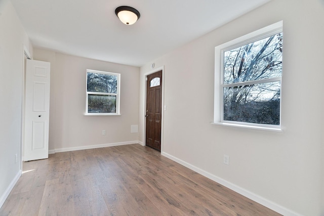 unfurnished room with plenty of natural light and light hardwood / wood-style floors