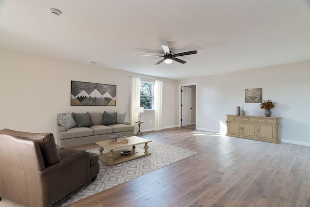 living room with ceiling fan and light hardwood / wood-style floors