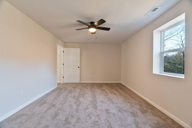 unfurnished room featuring light carpet and ceiling fan