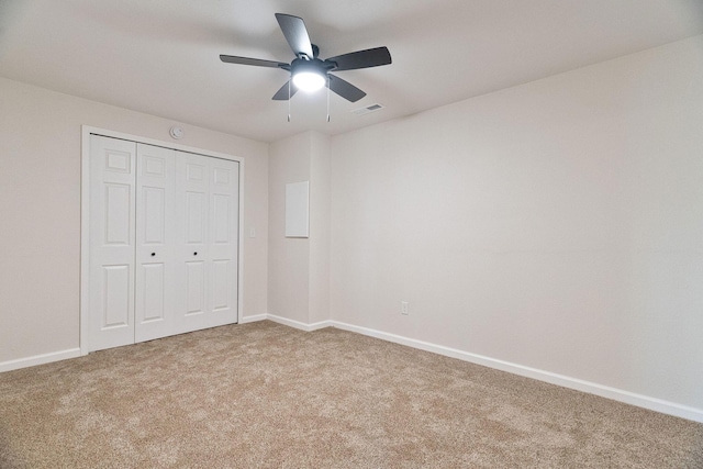 unfurnished bedroom with carpet flooring, ceiling fan, and a closet