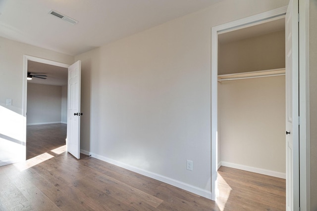 unfurnished bedroom with wood-type flooring and a closet