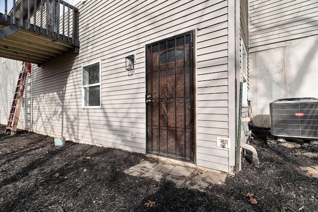 doorway to property with a balcony and central AC unit