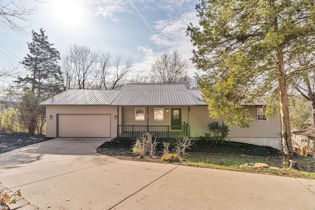 view of front facade featuring covered porch and a garage