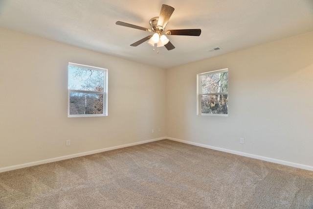 spare room featuring carpet floors and ceiling fan