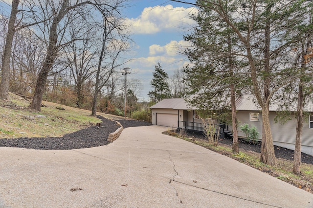 view of front of property with a porch and a garage