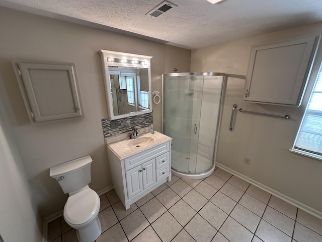 bathroom featuring tile patterned floors, vanity, a shower with door, and backsplash