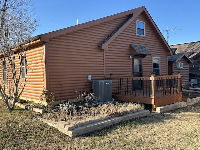 view of side of property with central AC and a wooden deck