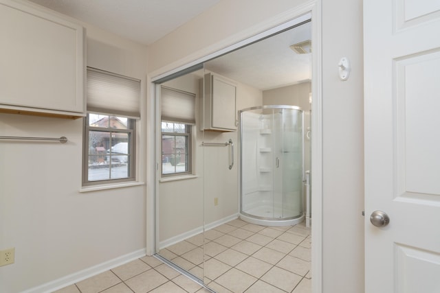 bathroom featuring tile patterned flooring and a shower with shower door