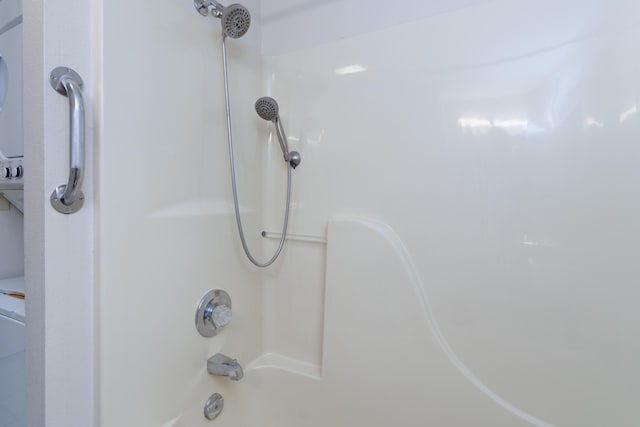 interior details featuring shower / bath combination