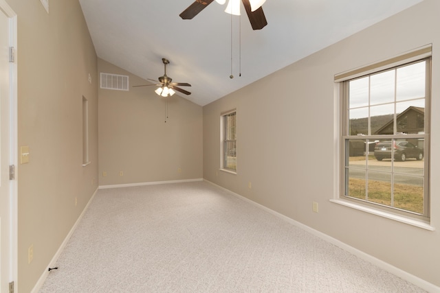 carpeted spare room featuring ceiling fan and lofted ceiling