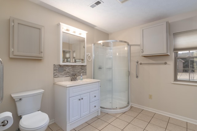 bathroom featuring walk in shower, tasteful backsplash, tile patterned floors, toilet, and vanity