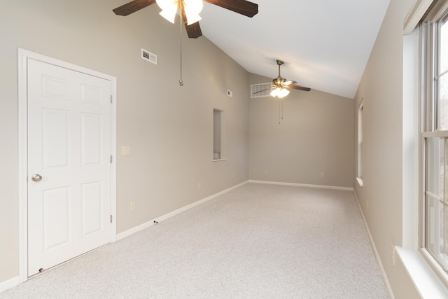 empty room with ceiling fan, high vaulted ceiling, and light colored carpet