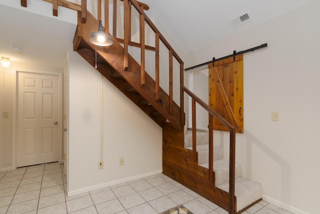 stairs featuring a barn door