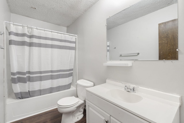 full bathroom with a textured ceiling, toilet, shower / tub combo with curtain, vanity, and hardwood / wood-style flooring