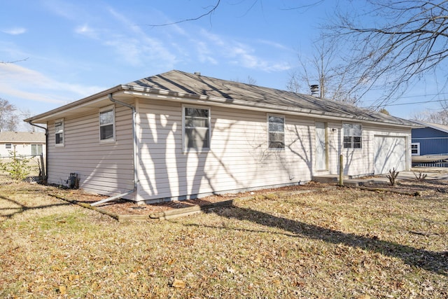 rear view of house with a lawn