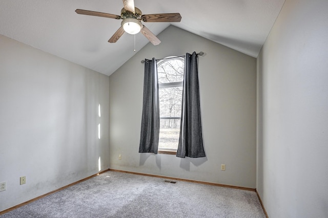 carpeted empty room with ceiling fan and lofted ceiling