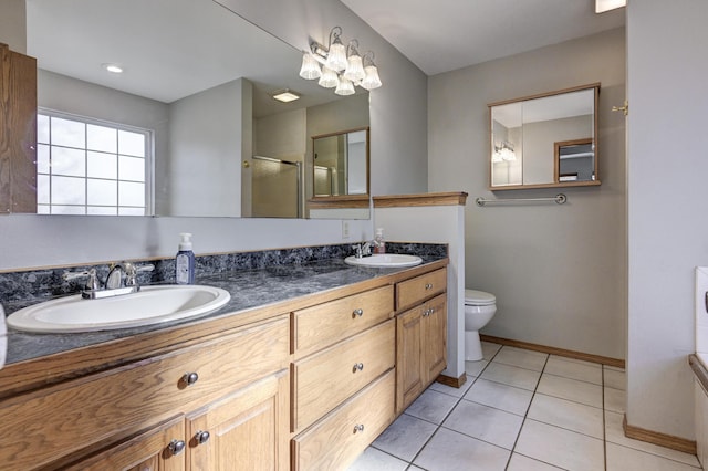 bathroom with tile patterned flooring, vanity, toilet, and an enclosed shower