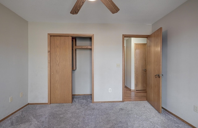 unfurnished bedroom featuring a closet, light colored carpet, and ceiling fan