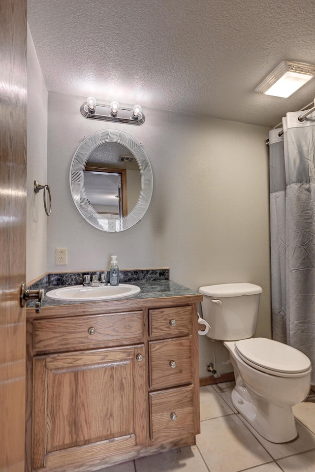 bathroom with a shower with shower curtain, tile patterned floors, vanity, a textured ceiling, and toilet