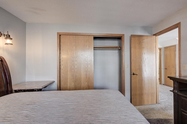 bedroom featuring light colored carpet and a closet