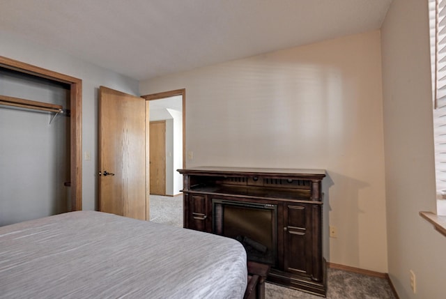 bedroom with light colored carpet and a closet