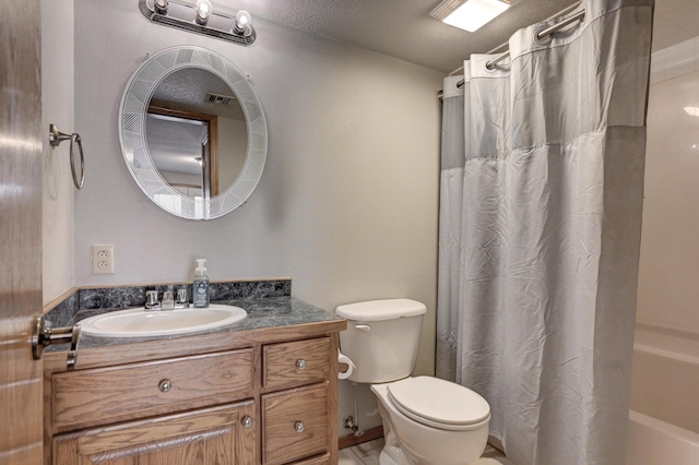 bathroom with vanity, a textured ceiling, and toilet