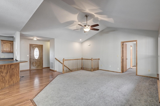 interior space featuring ceiling fan, light hardwood / wood-style flooring, and lofted ceiling