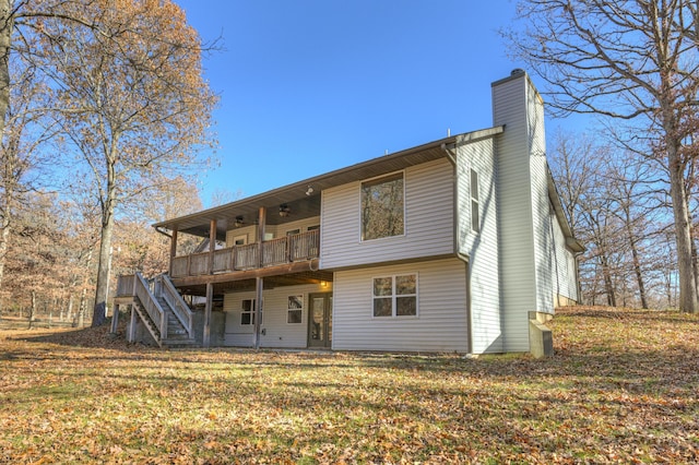 back of house with a lawn and a deck