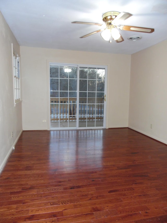 spare room with ceiling fan and dark hardwood / wood-style floors