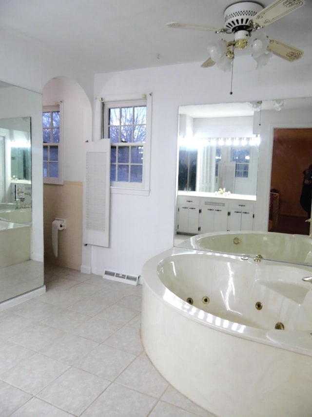 bathroom with tile patterned flooring, vanity, and a washtub