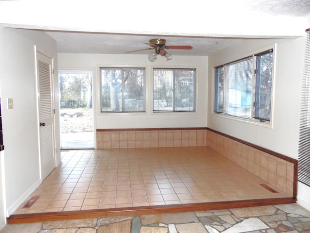 interior space with ceiling fan