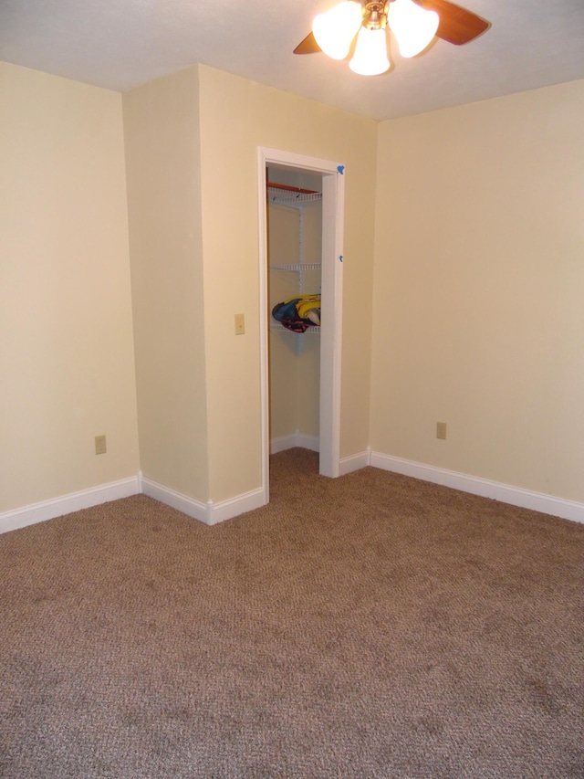 unfurnished bedroom with carpet flooring, ceiling fan, and a closet