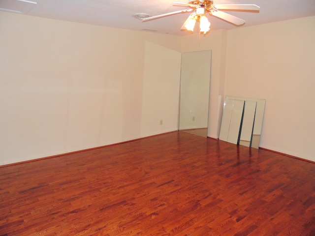 empty room with ceiling fan and wood-type flooring