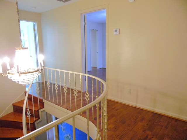 hall with a chandelier and dark hardwood / wood-style floors