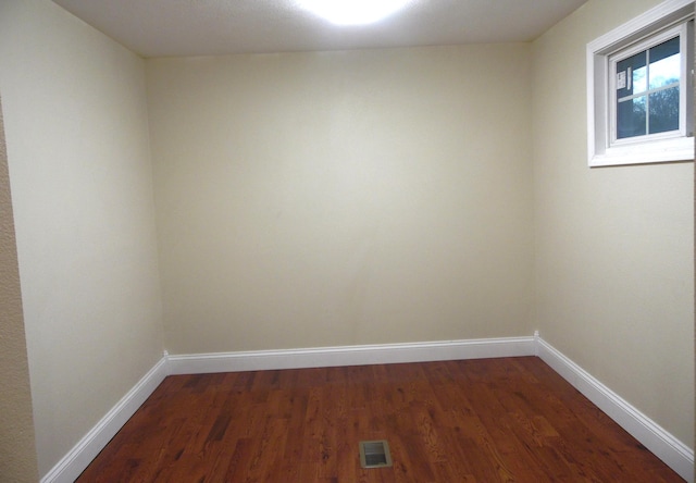 empty room featuring dark wood-type flooring