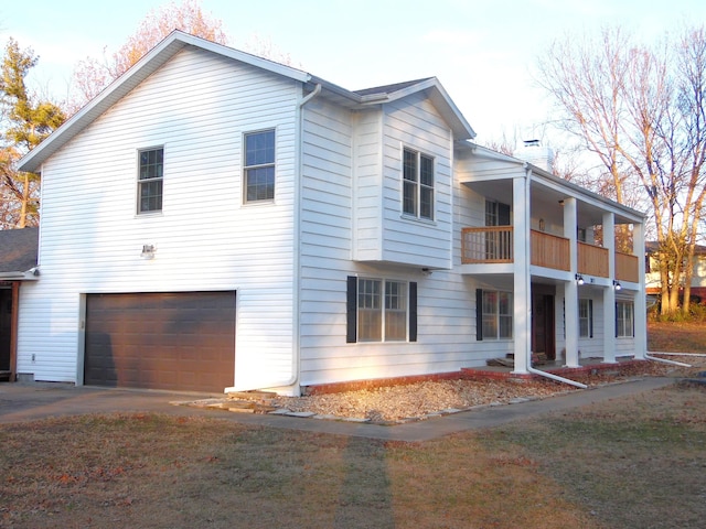 view of side of home with a balcony and a garage