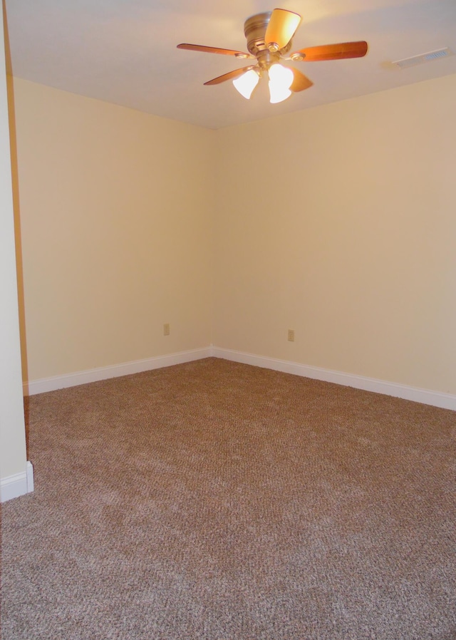 carpeted spare room featuring ceiling fan