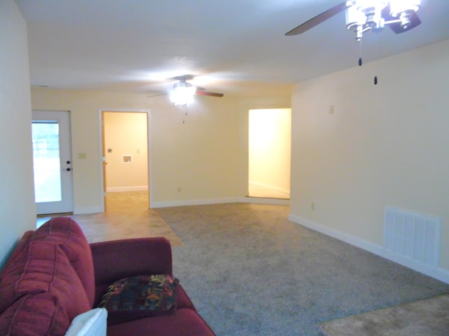 carpeted living room with ceiling fan