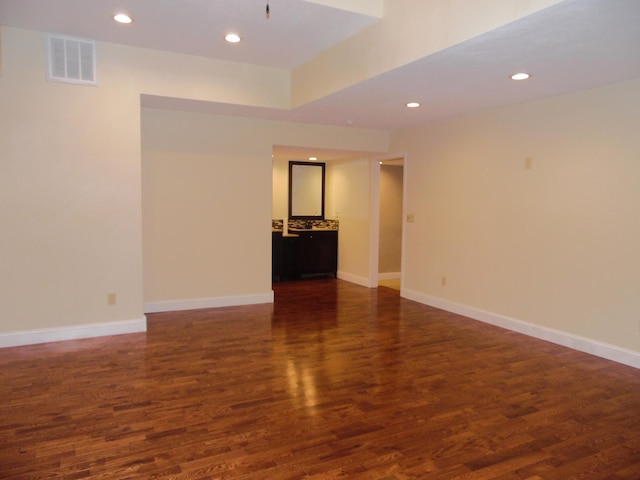 spare room featuring dark wood-type flooring