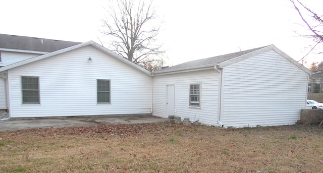 rear view of house with a patio area and a yard