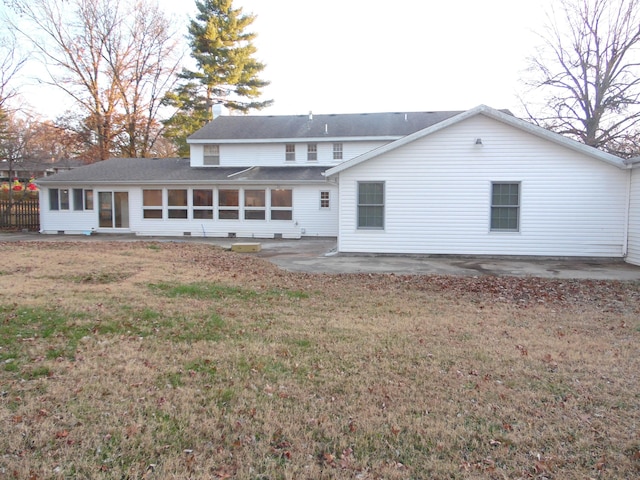 rear view of house featuring a patio area and a lawn