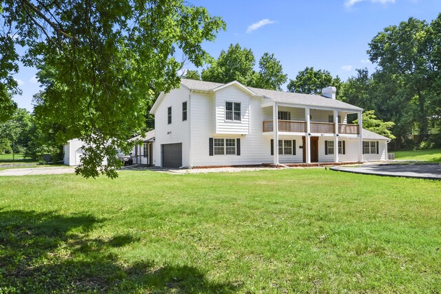 3011 E Lamonta Dr, Springfield, MO 65804 - view of front of property featuring a garage, a chimney, a balcony, and a front lawn